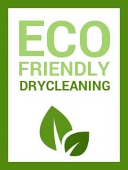 Green-bordered sign with the words "Eco Friendly Drycleaning" above two green leaves, indicating environmentally conscious dry cleaning services.